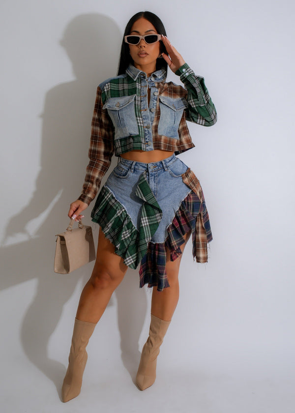 Cropped tailored button down jacket with a mix of denim and patchwork tartan print, with matching asymmetrical denim skirt features plaid ruffle accents and a tie-waist belt
