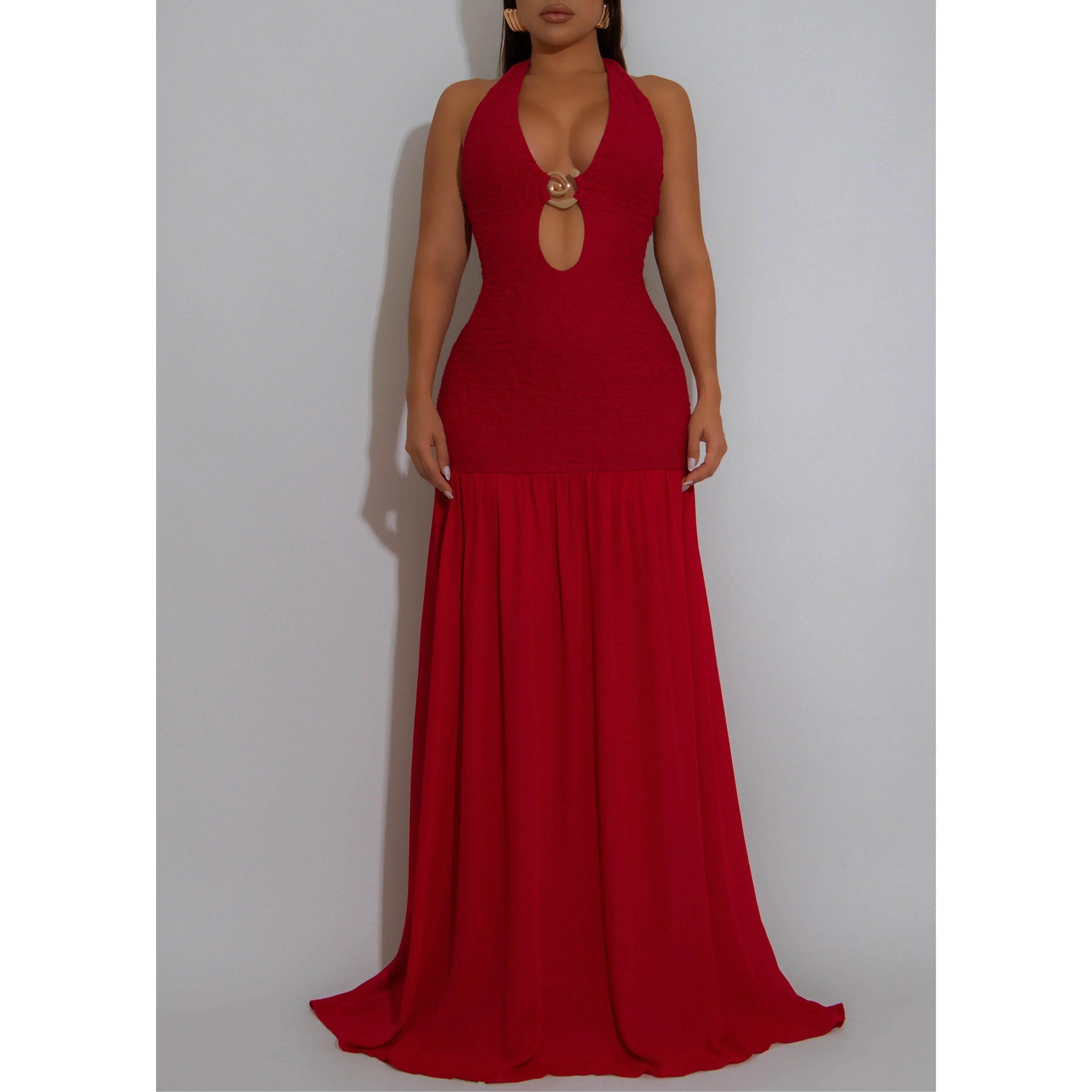 Woman wearing a red ruched halter neck gown with gold embellishment by the bust area and chiffon style maxi skirt 