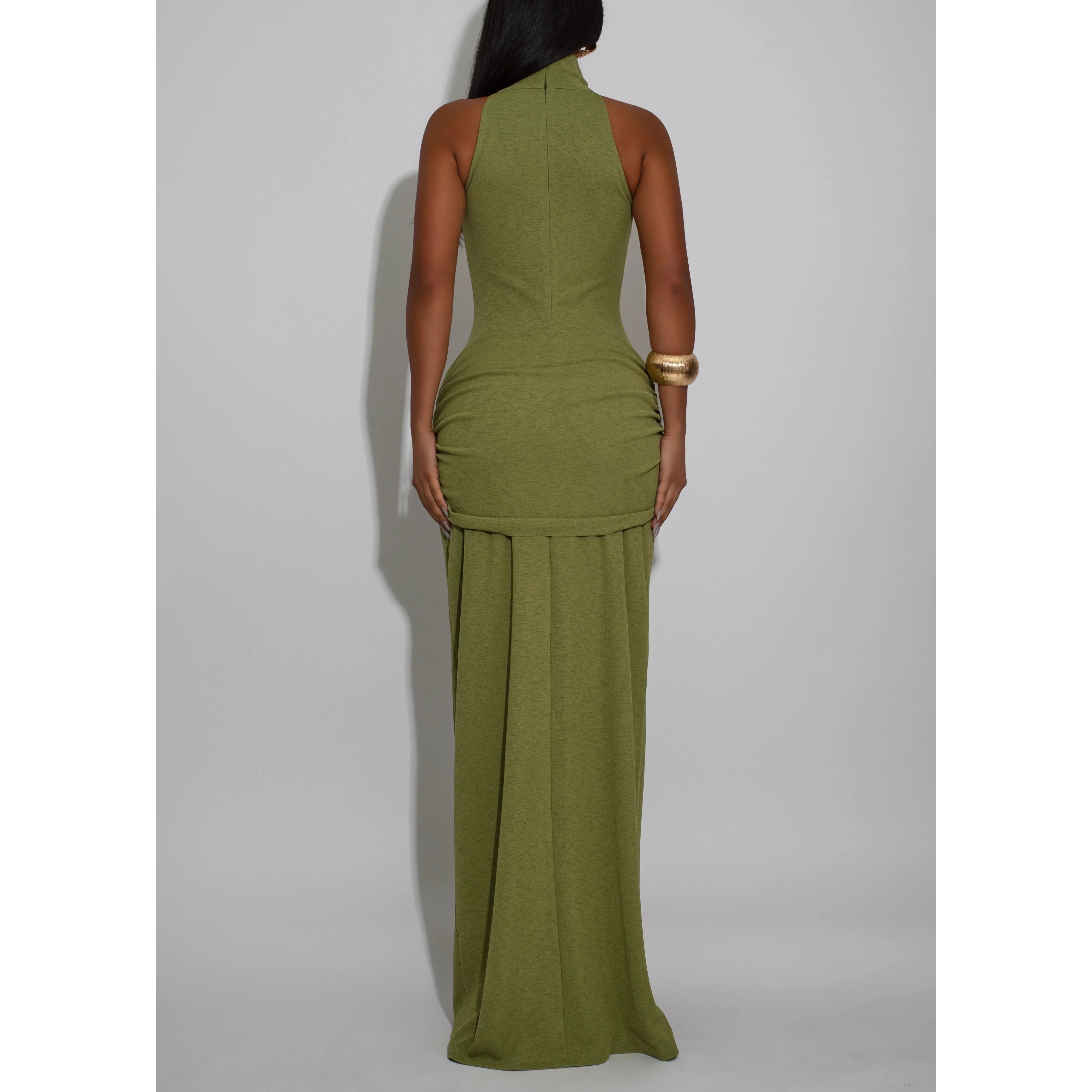 Woman wearing a mock neck sleeveless green halter neck maxi dress with front tie draping detail.  