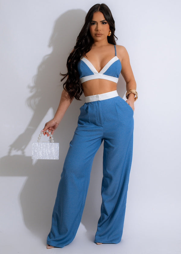 Rich denim  blue is complemented by contrasting white piping on the bikini-style top, with adjustable straps. Paired with matching pants featuring a relaxed fit and easy zipper closure two side pockets .