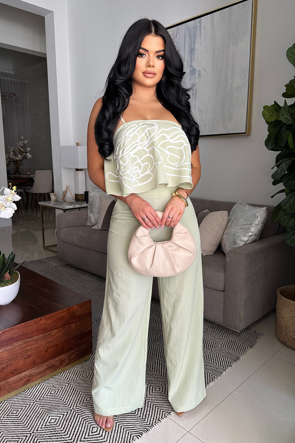 Sage green pant set with breezy flounce top with white embroidery detail , adjustable straps and tailored high waisted wide leg pants with zipper closure