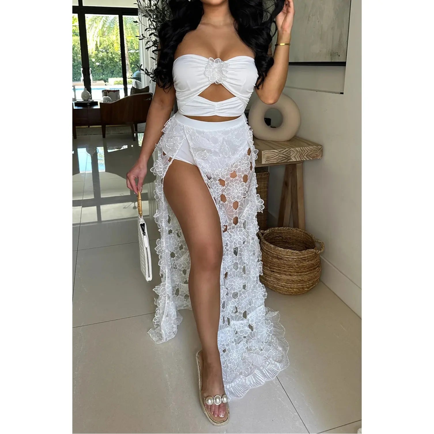 Floral White two-piece set with  ruched top with delicate straps and a flowy  maxi skirt adorned with intricate floral lace details and a side slit 